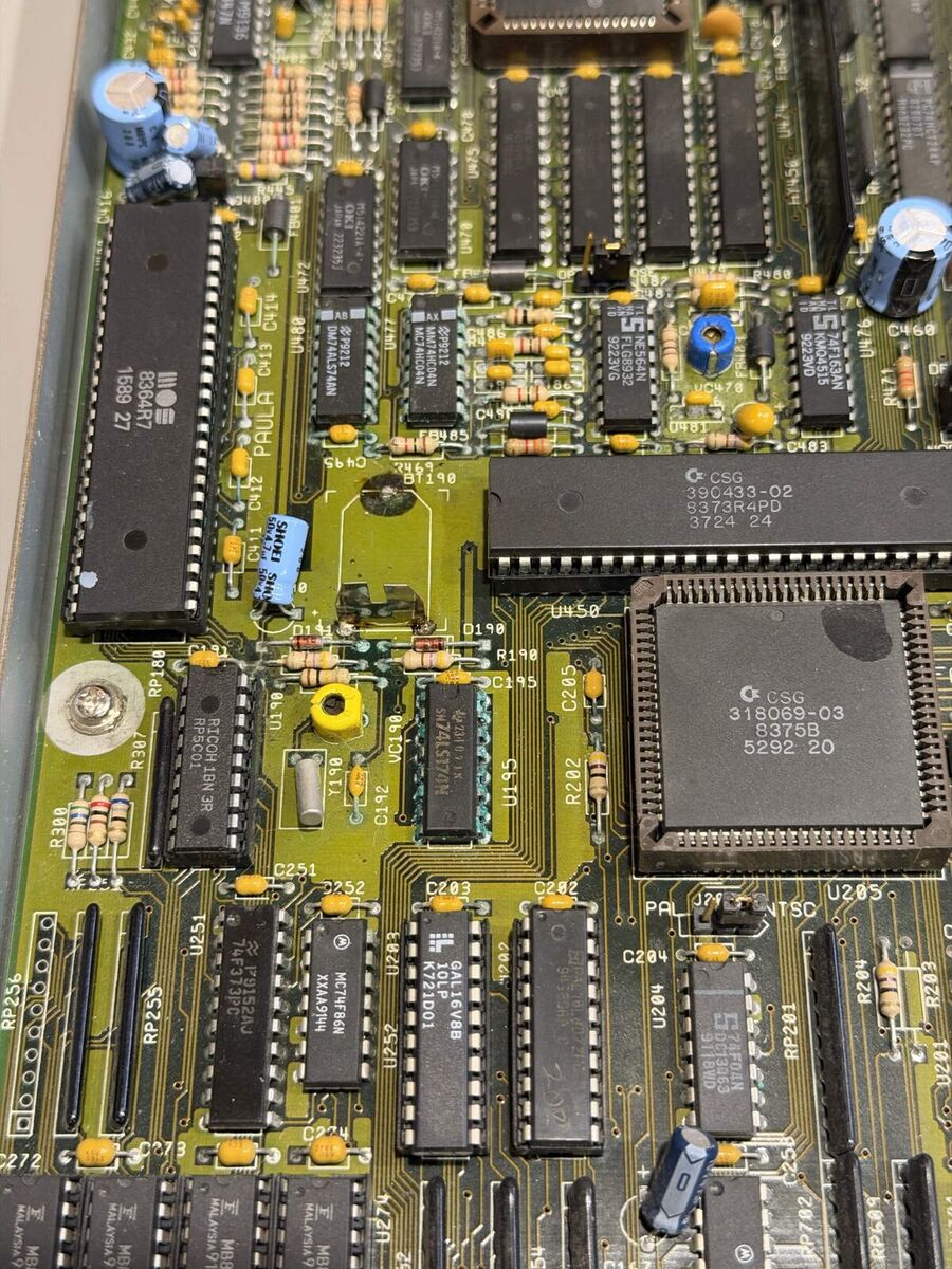 Amiga 3000 motherboard before repair, with green corrosion around the clock battery