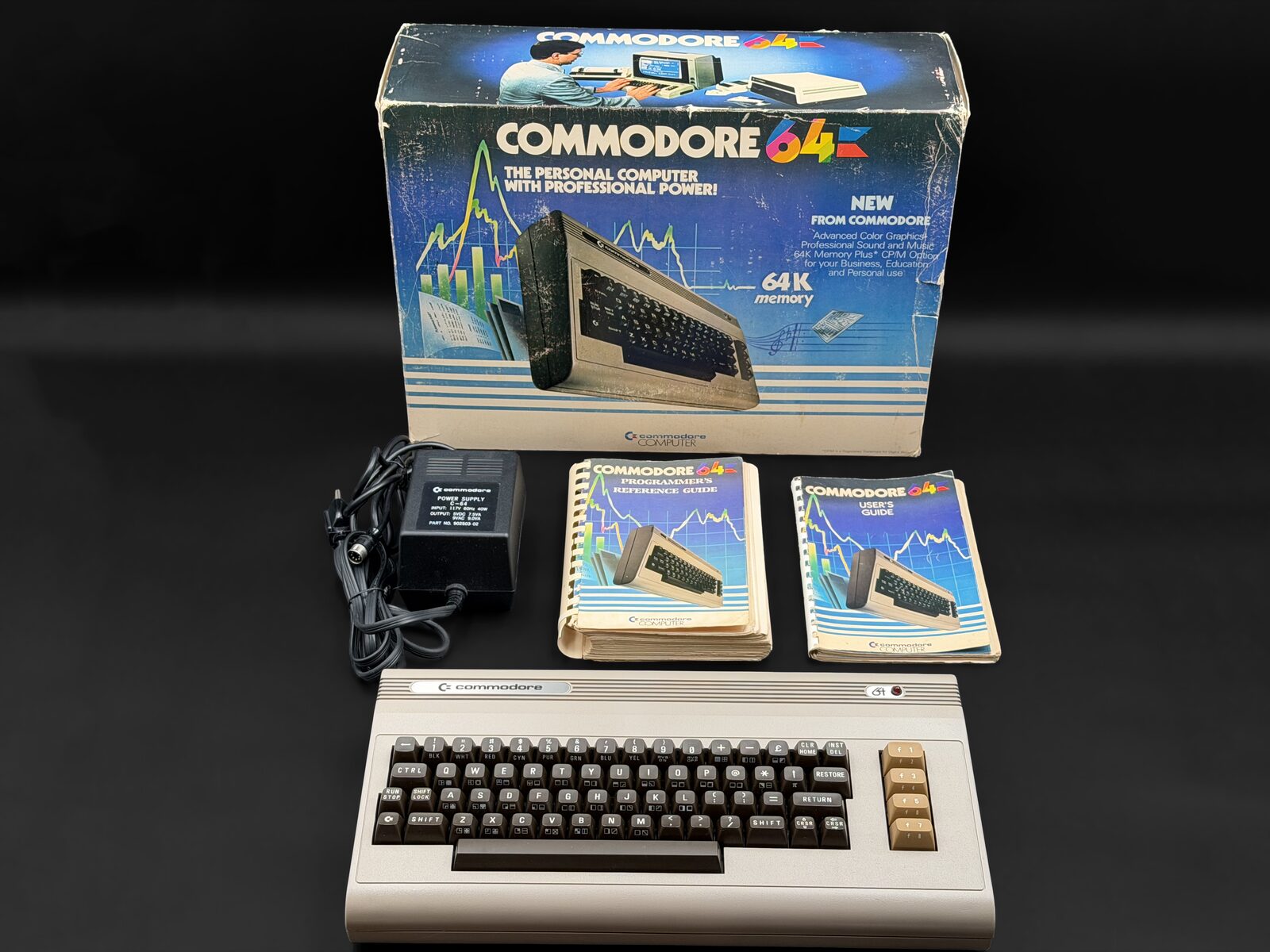 Silver-label Commodore 64 with its box, power supply, User's Guide and Programmer's Reference Guide